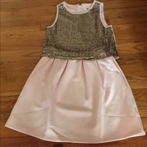 A pink and gold sequined girls dress.